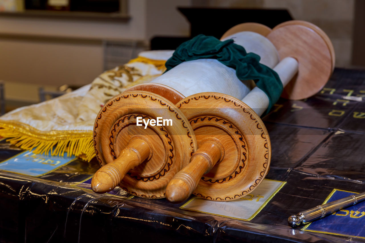 Close-up of tied old traditional scroll on table