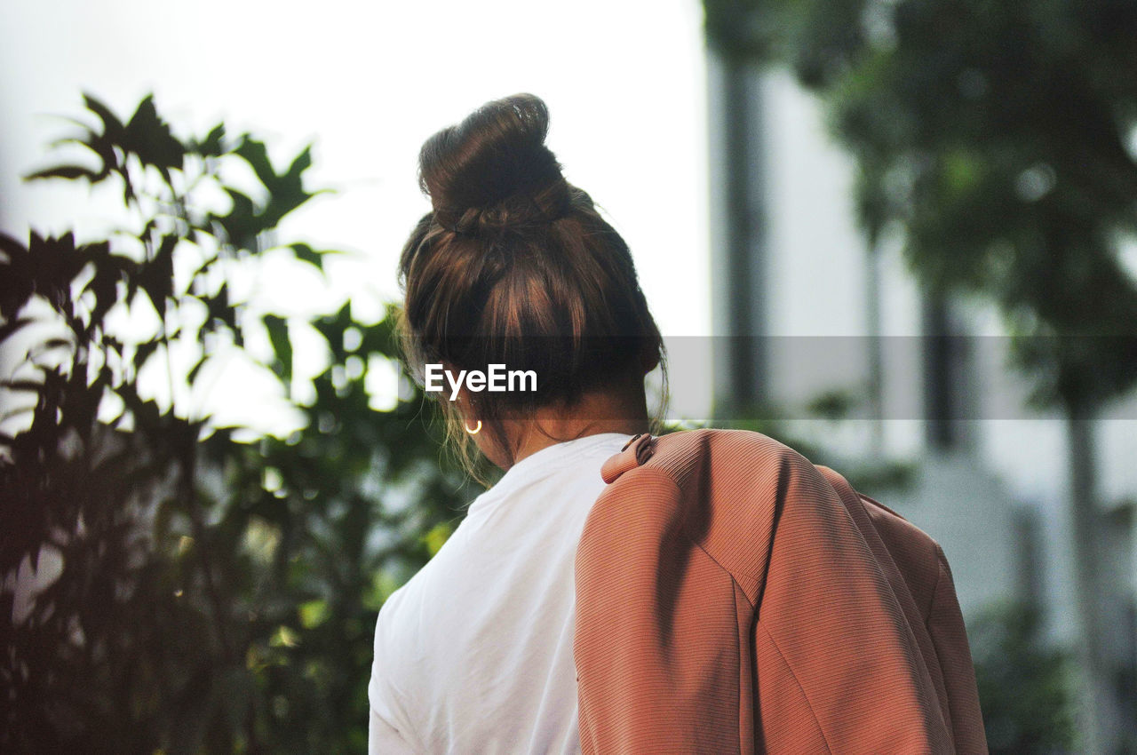 REAR VIEW OF WOMAN LOOKING AT VIEW
