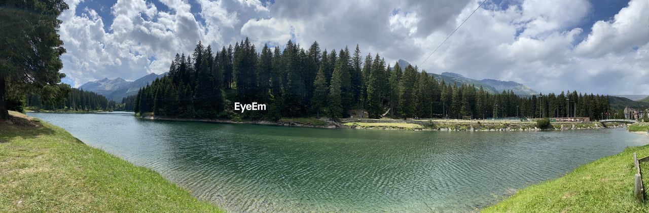 PANORAMIC SHOT OF LAKE BY TREES AGAINST SKY