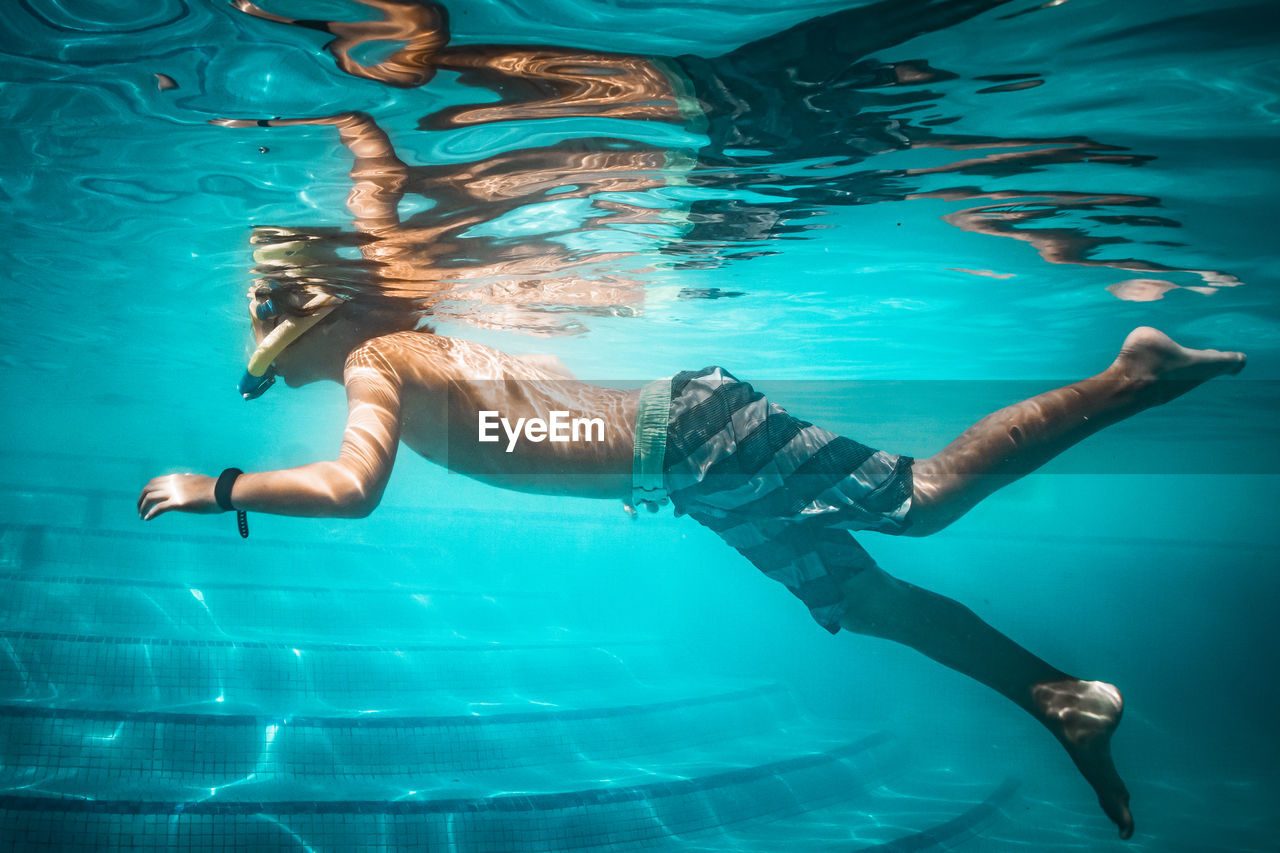 MAN SWIMMING IN SEA