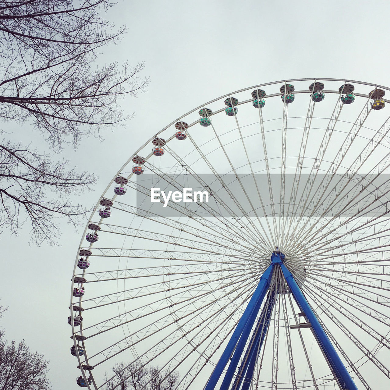 Low angle view of ferris wheel against clear sky