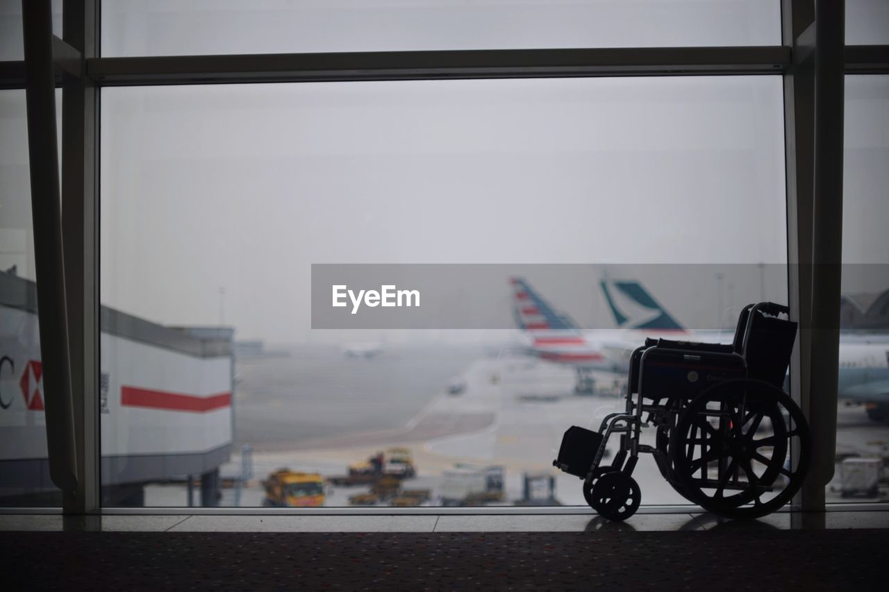 Wheelchair by window in airport waiting room