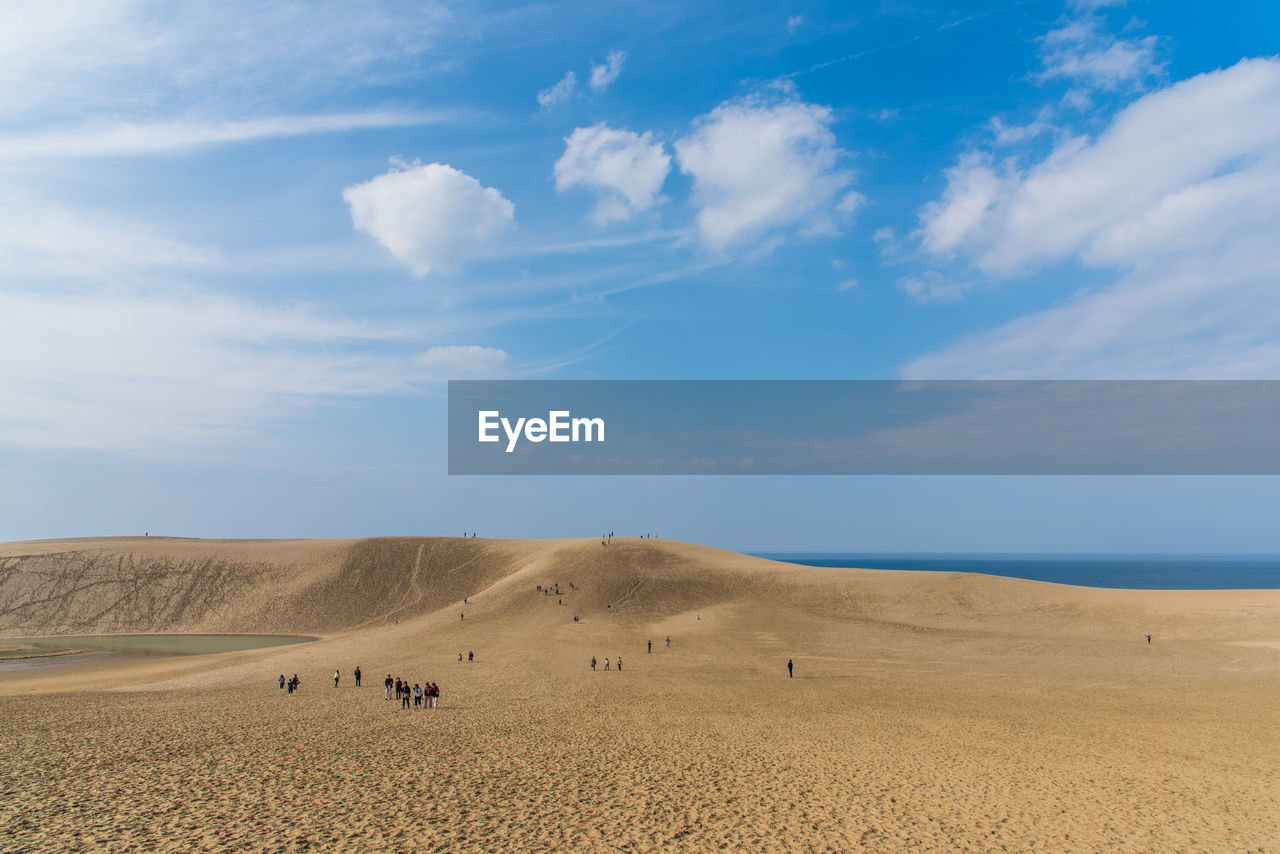 People on beach against clear sky