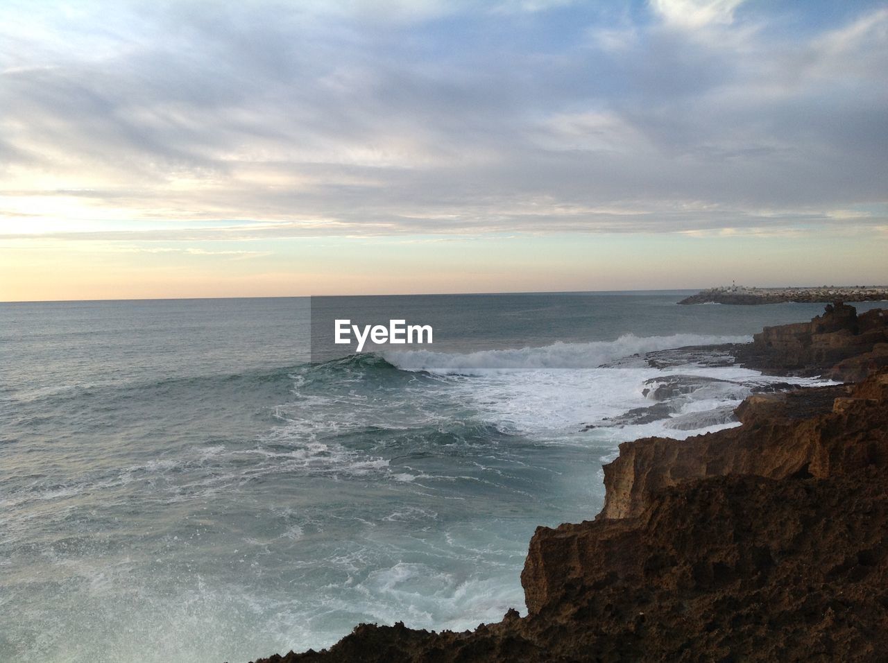 Scenic view of sea against dramatic sky