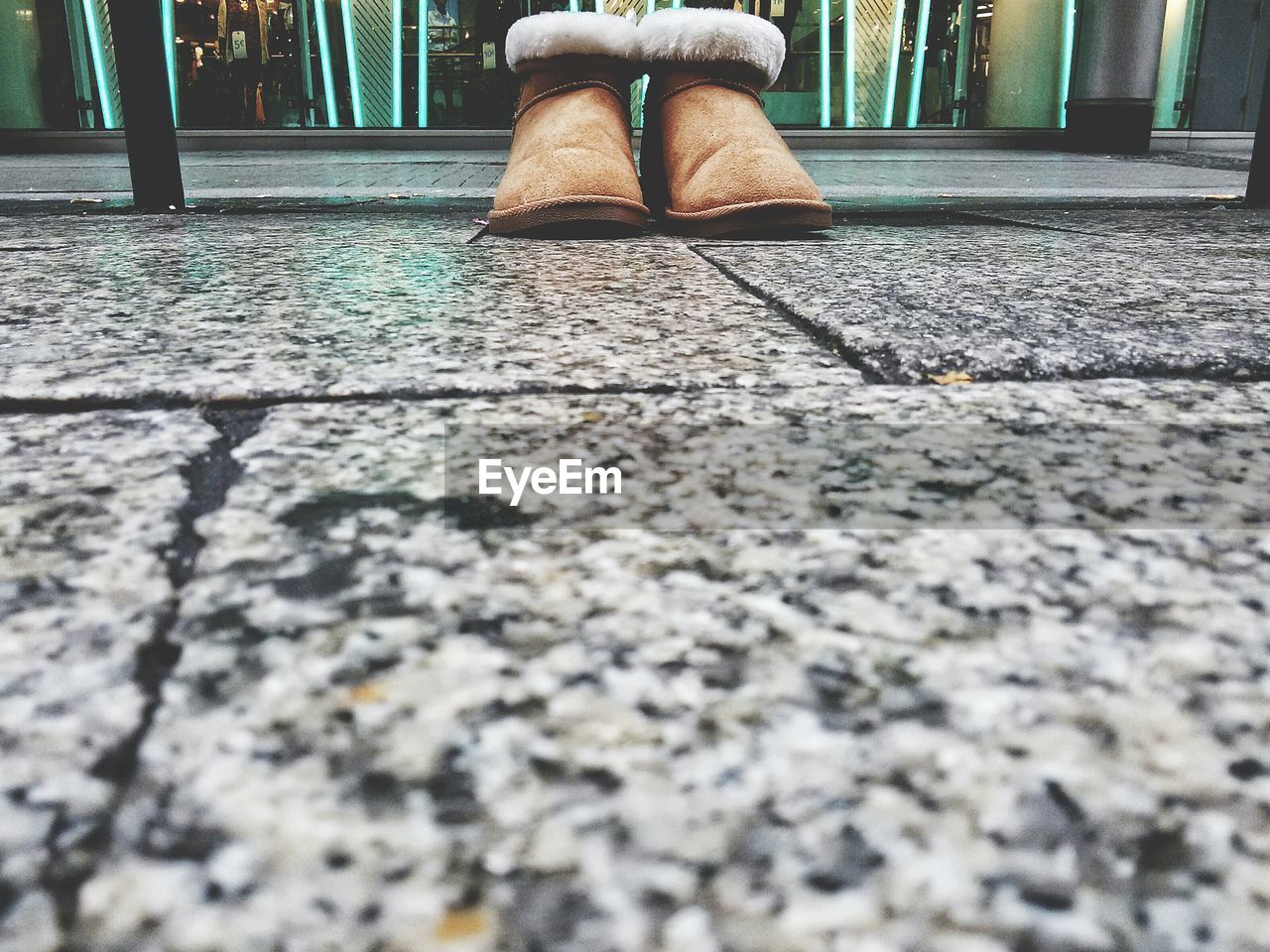 Selective focus of shoes on walkway