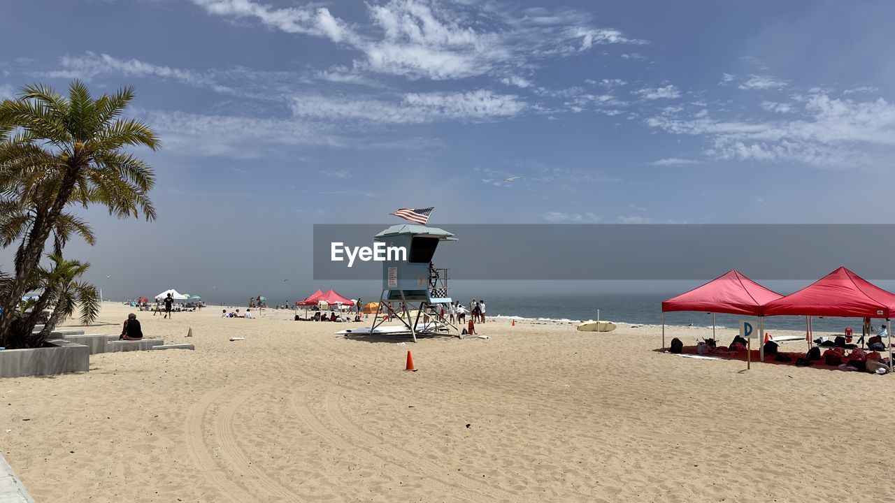 Scenic view of beach against sky life guard house