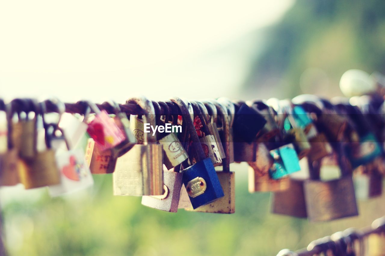 Close-up of padlocks hanging on metal