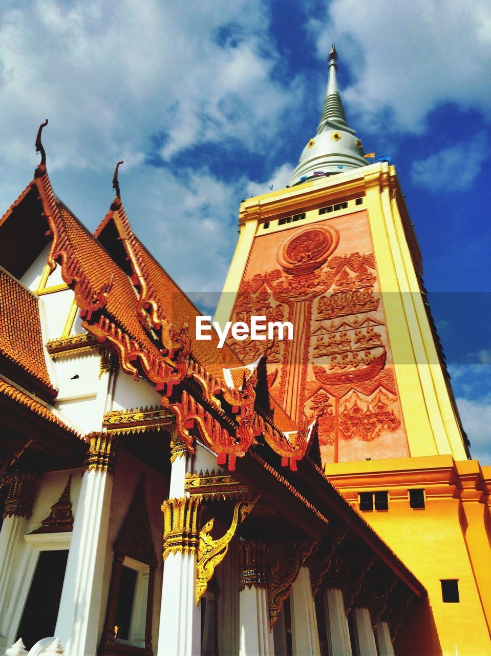 Low angle view of wat dhammamongkol against cloudy sky