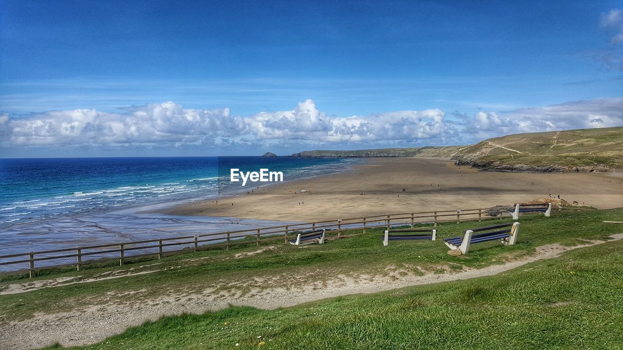 PANORAMIC VIEW OF BEACH AGAINST BLUE SKY