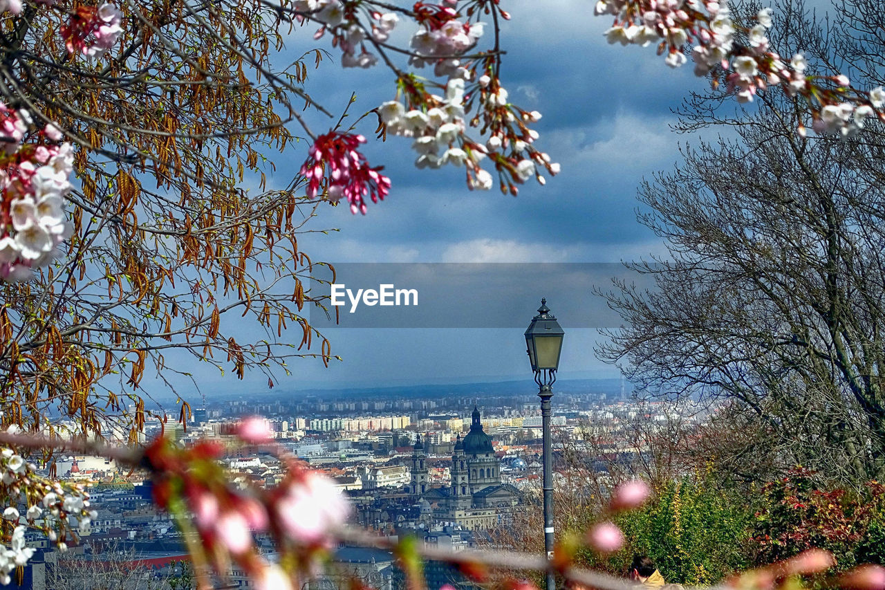 Scenic view of cityscape against cloudy sky