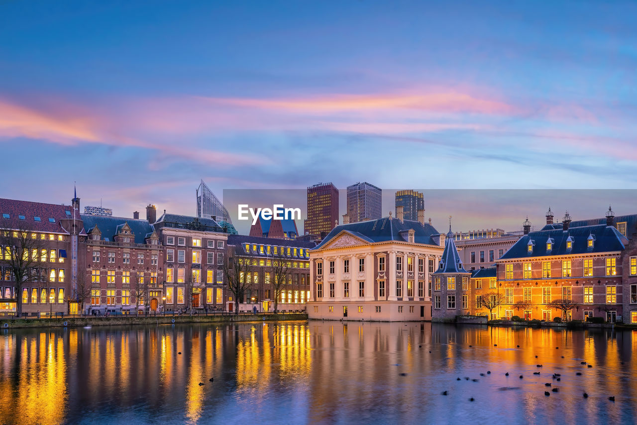 buildings in city against sky during sunset