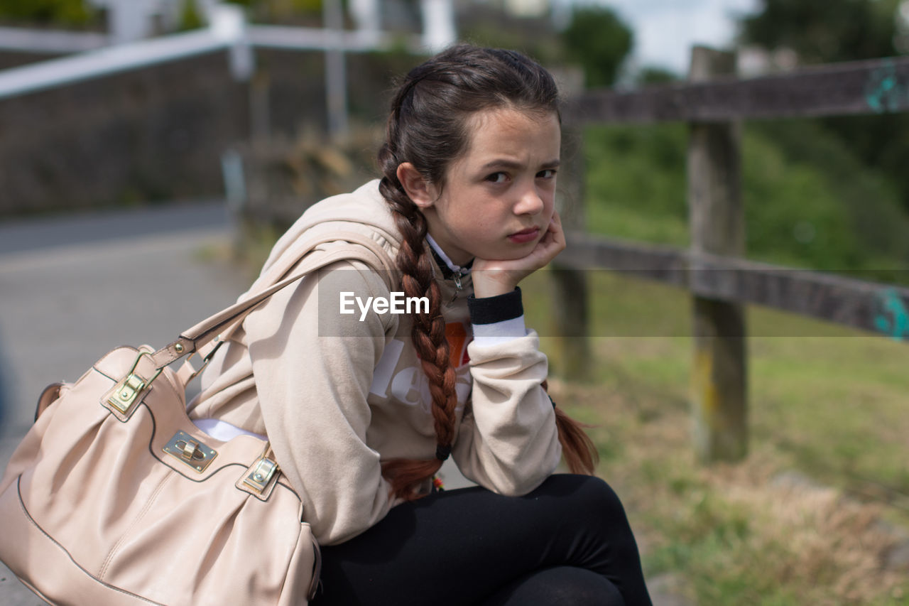 Portrait of girl sitting outdoors