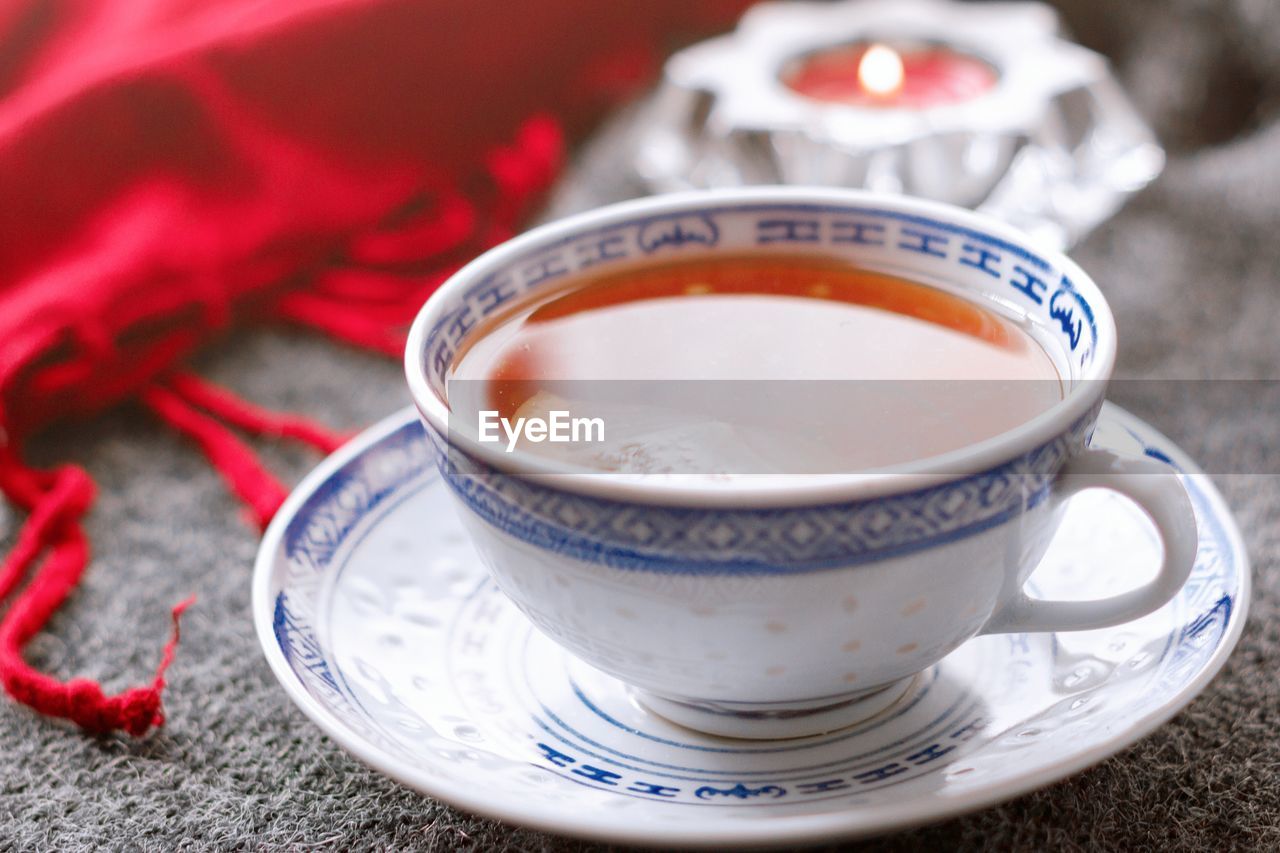 Cup of tea on a gray and red background. cozy mood with tea