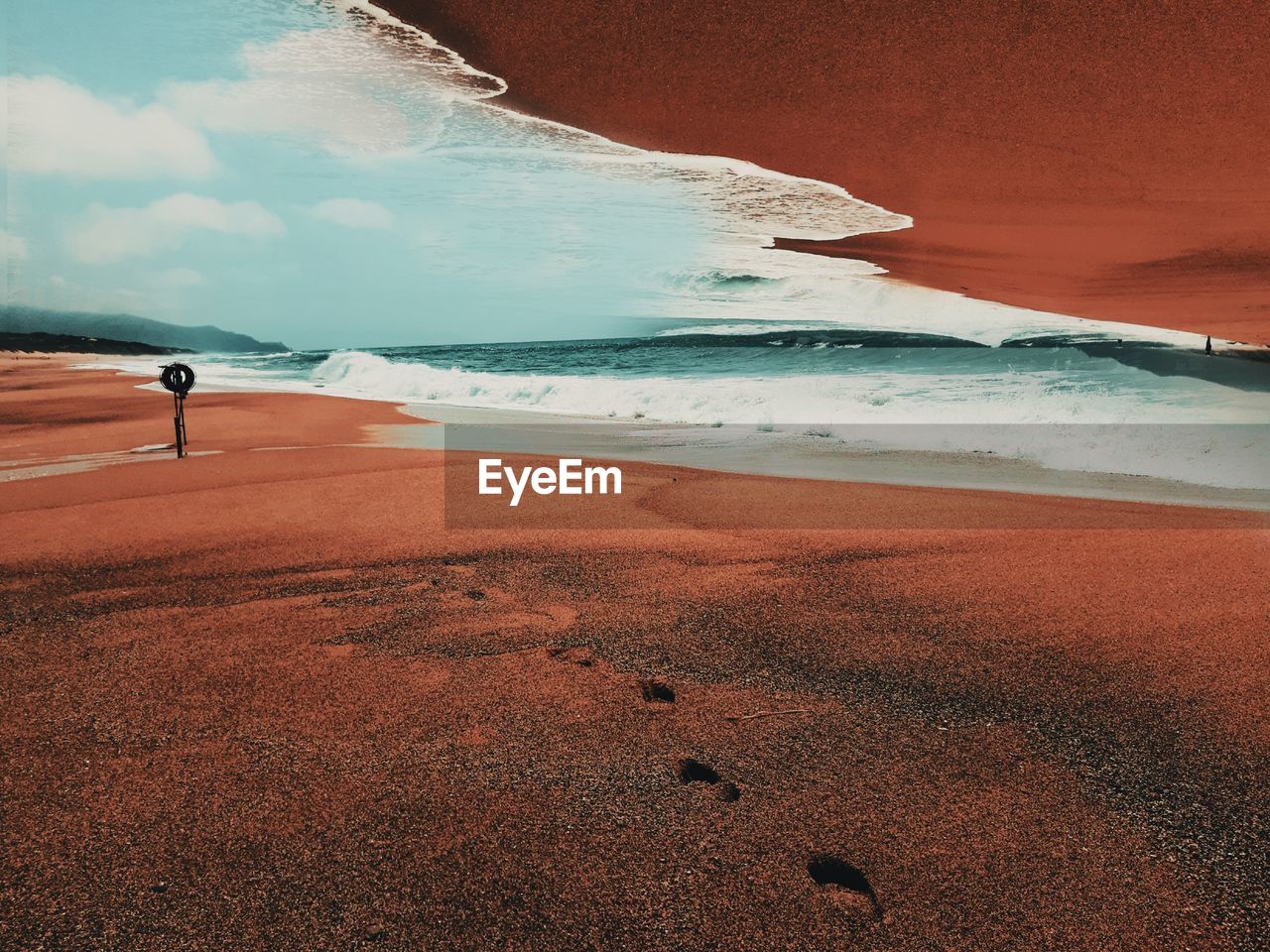 Surreal scenic view of beach by sea against sky