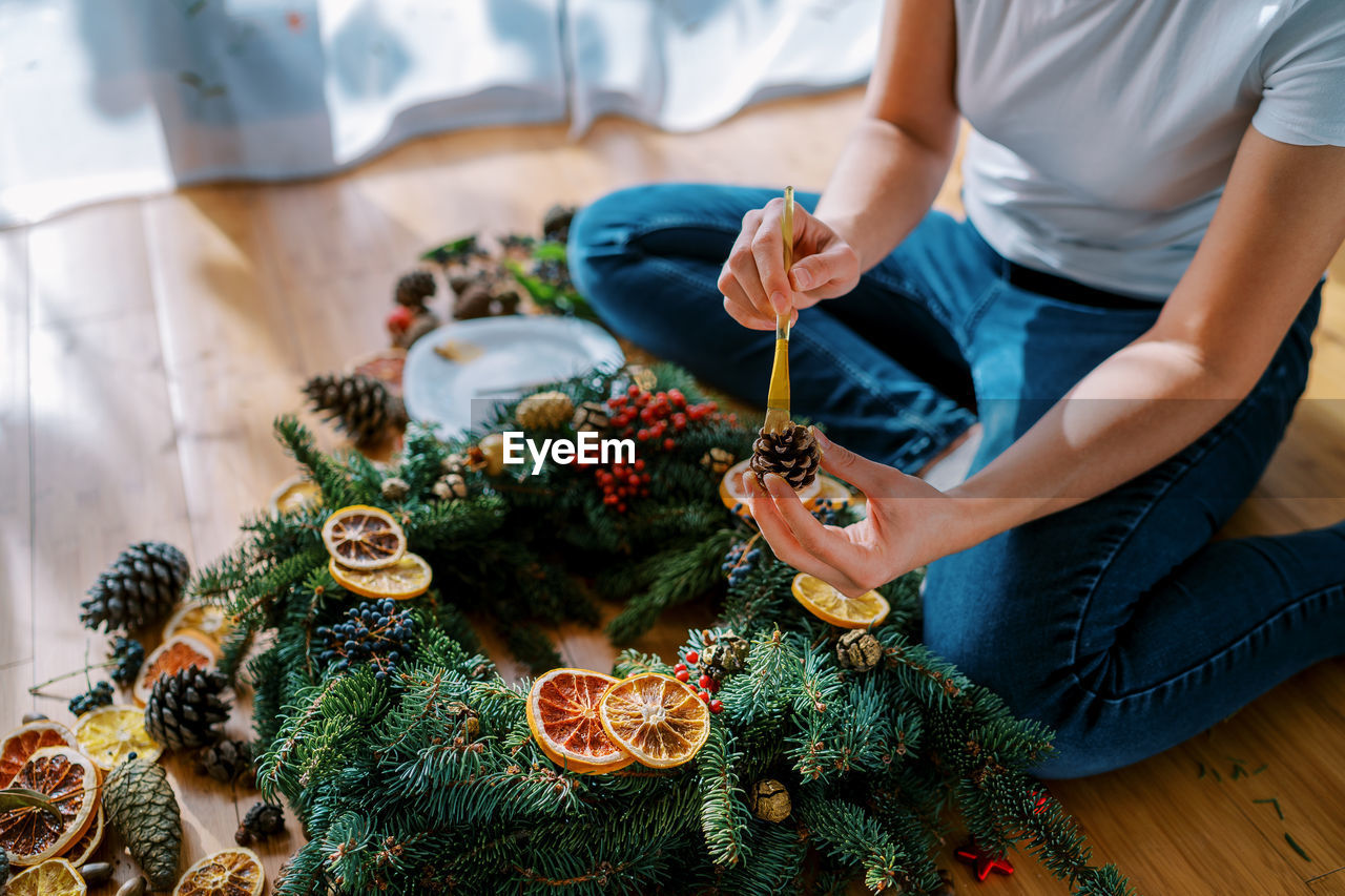 midsection of man holding christmas tree