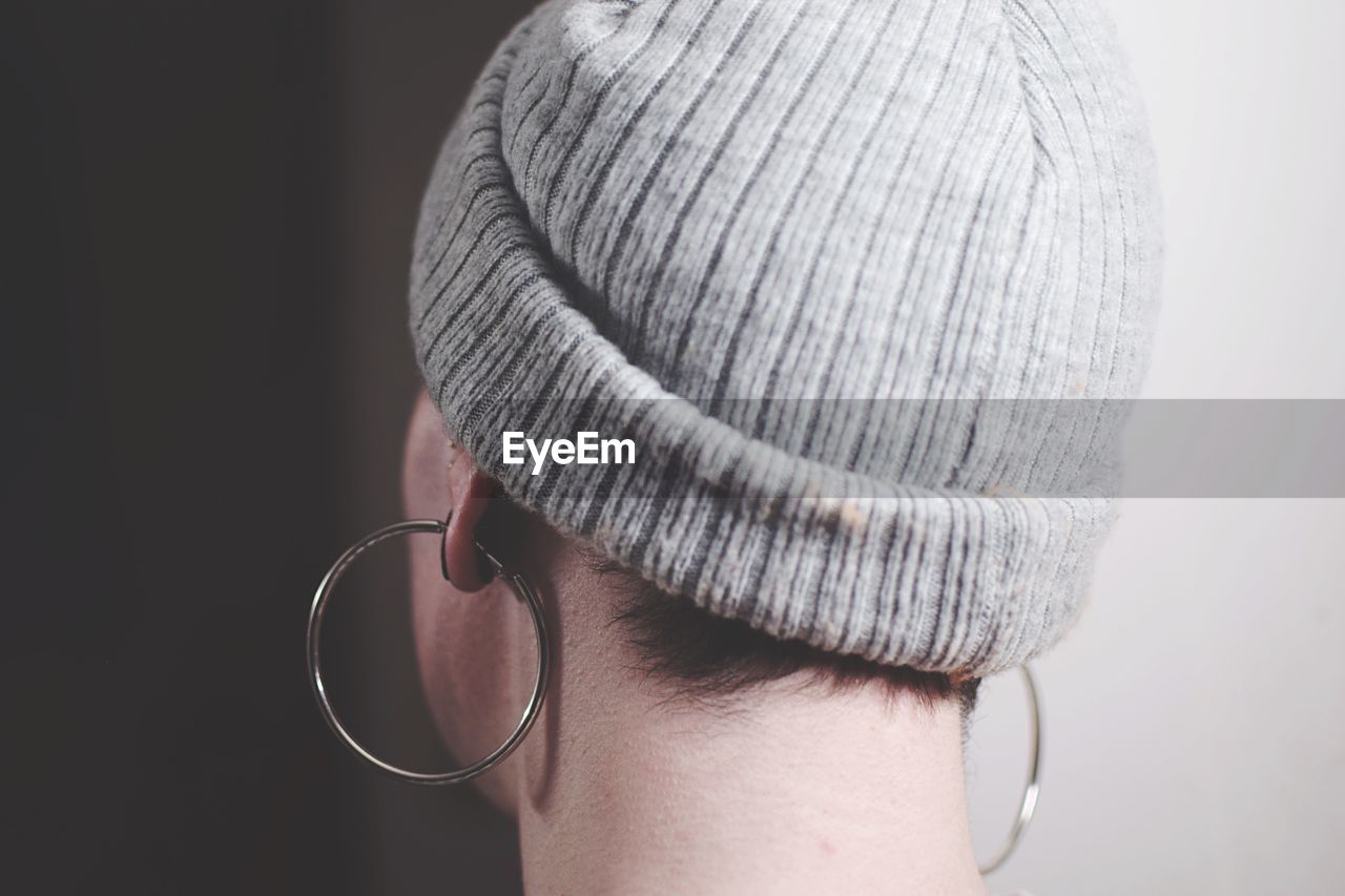 Close-up of woman wearing earrings and hat