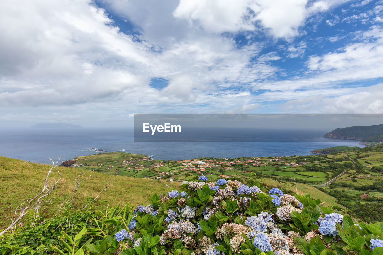 Scenic view of sea against cloudy sky