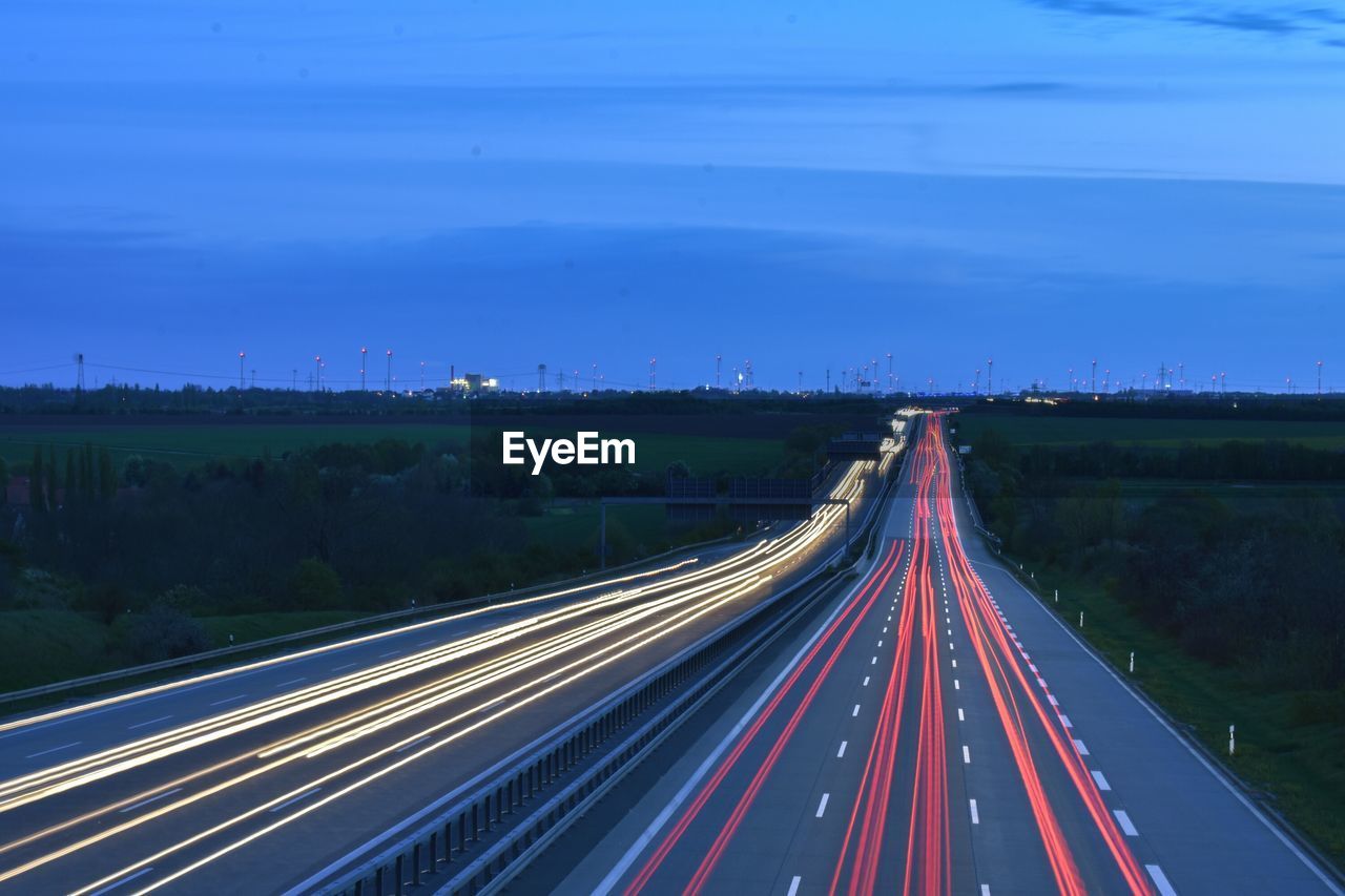 High angle view of light trails on highway at night