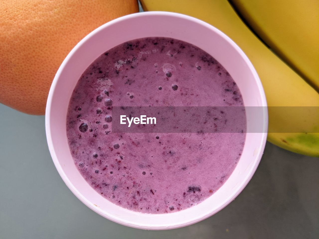 food and drink, food, healthy eating, wellbeing, smoothie, fruit, produce, drink, freshness, refreshment, pink, indoors, household equipment, purple, banana, bowl, directly above, no people, high angle view, close-up, studio shot, drinking glass, plant