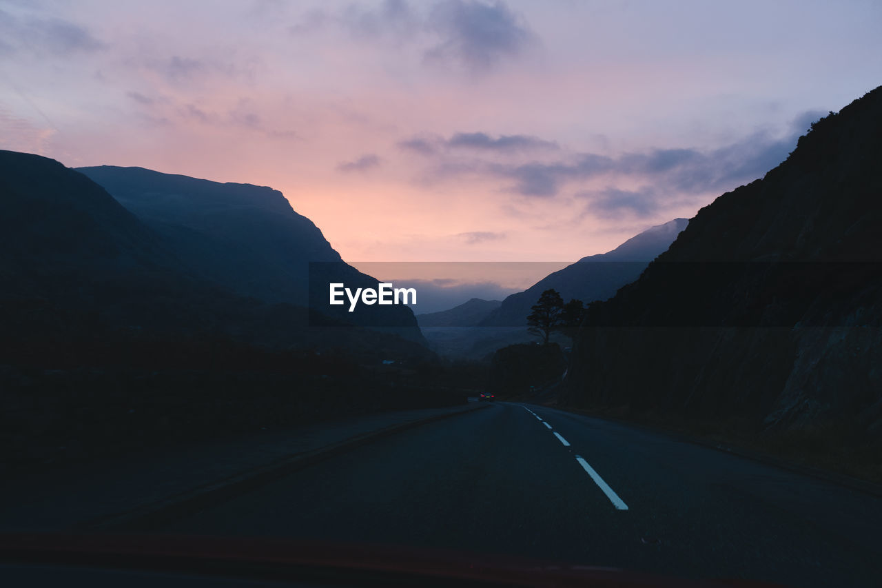 ROAD ON MOUNTAIN AGAINST SKY DURING SUNSET