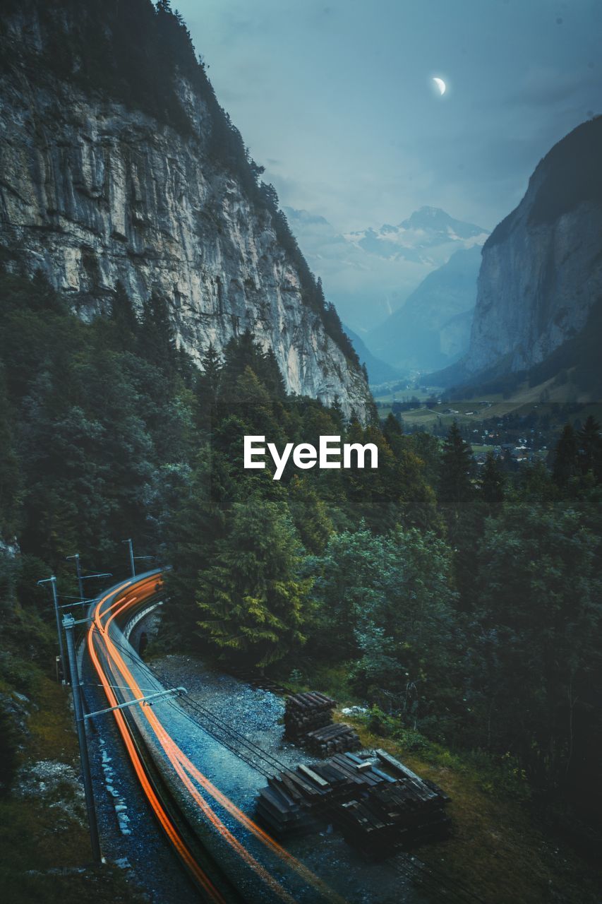 Aerial view of mountains by road against sky