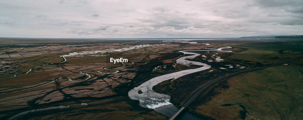 Aerial view of landscape and sea against sky