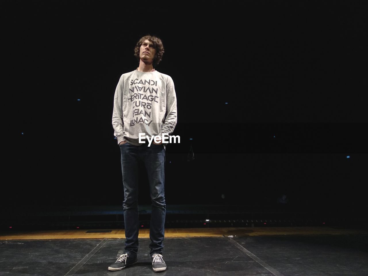 Man standing on stage against sky at night