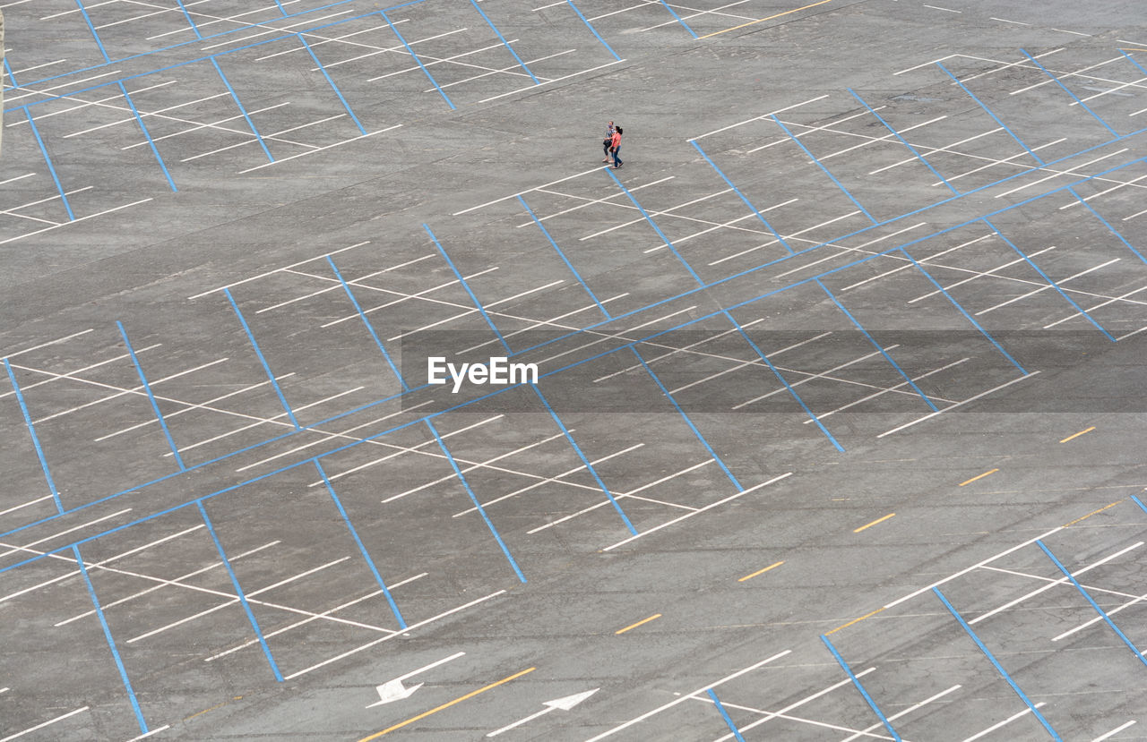 High angle view of man walking on parking area.