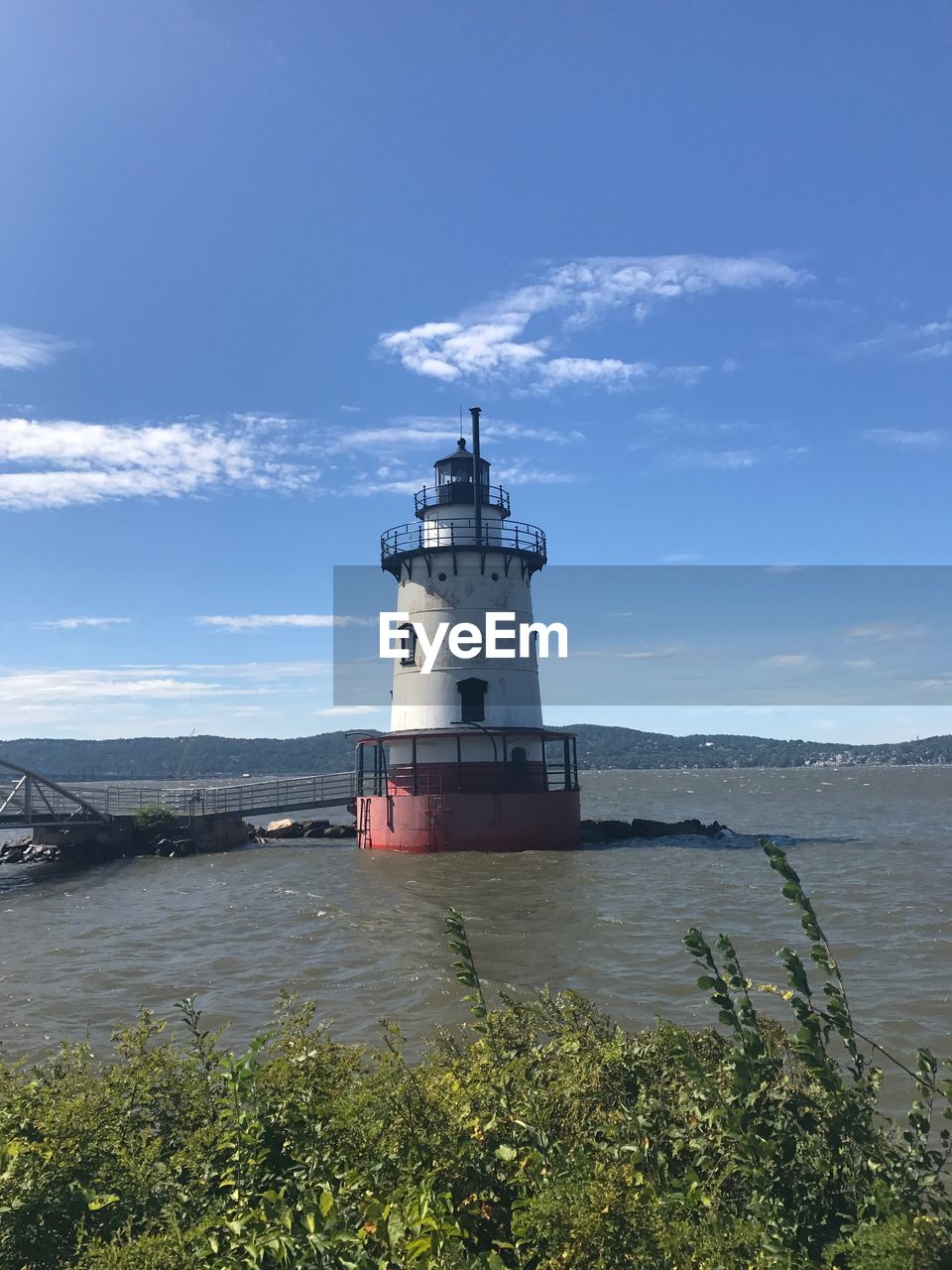 LIGHTHOUSE AMIDST SEA AGAINST SKY