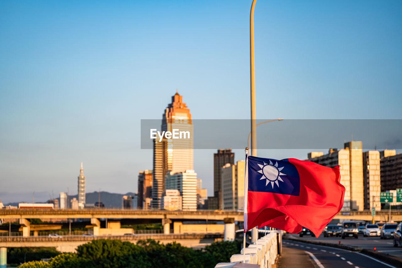 VIEW OF BUILDINGS AGAINST SKY IN CITY AGAINST BLUE BACKGROUND