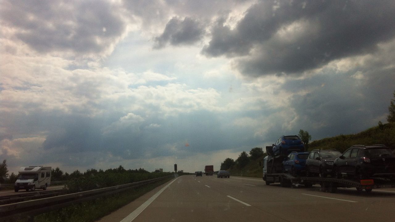 VIEW OF ROAD AGAINST CLOUDY SKY