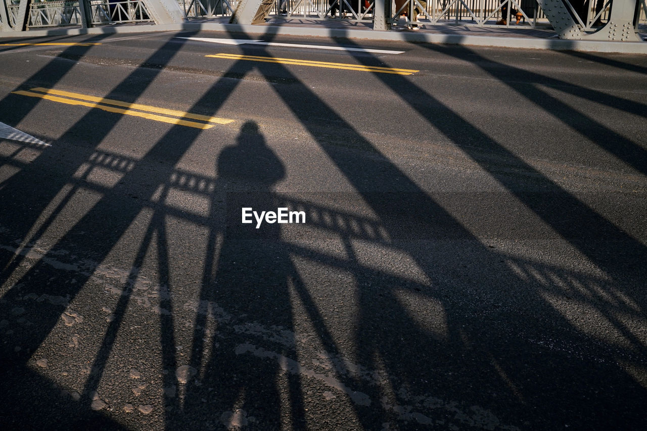 HIGH ANGLE VIEW OF PEOPLE CROSSING ROAD