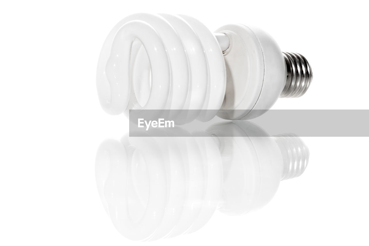 Close-up of light bulb against white background