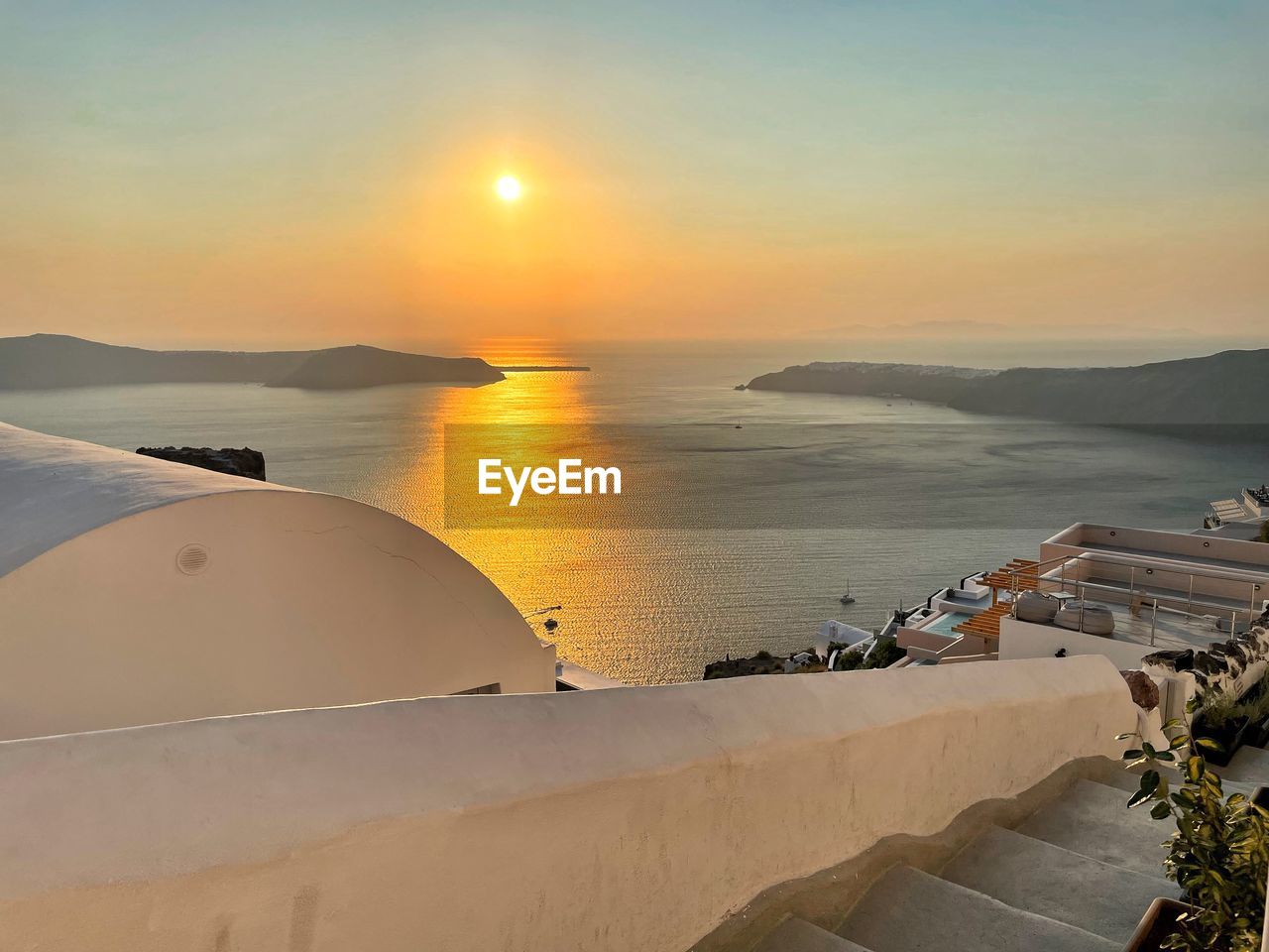 water, sea, sky, sunset, nature, scenics - nature, beauty in nature, land, ocean, sun, travel destinations, beach, travel, architecture, tranquility, coast, sunlight, tranquil scene, tourism, no people, sand, outdoors, environment, building exterior, horizon over water, built structure, vacation, transportation, landscape, holiday, horizon, trip, high angle view, shore, mountain, nautical vessel, idyllic, orange color, seascape