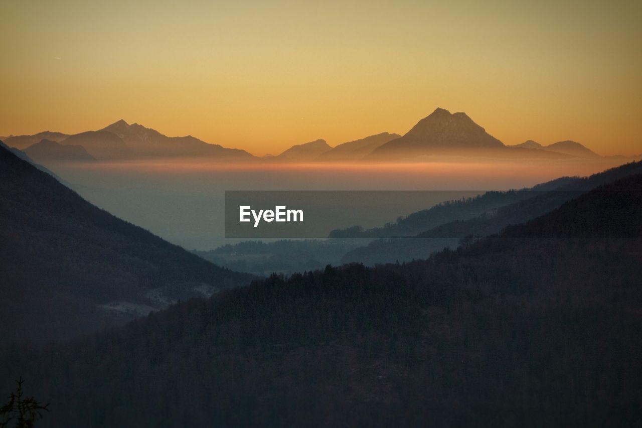 SCENIC VIEW OF MOUNTAINS DURING SUNSET