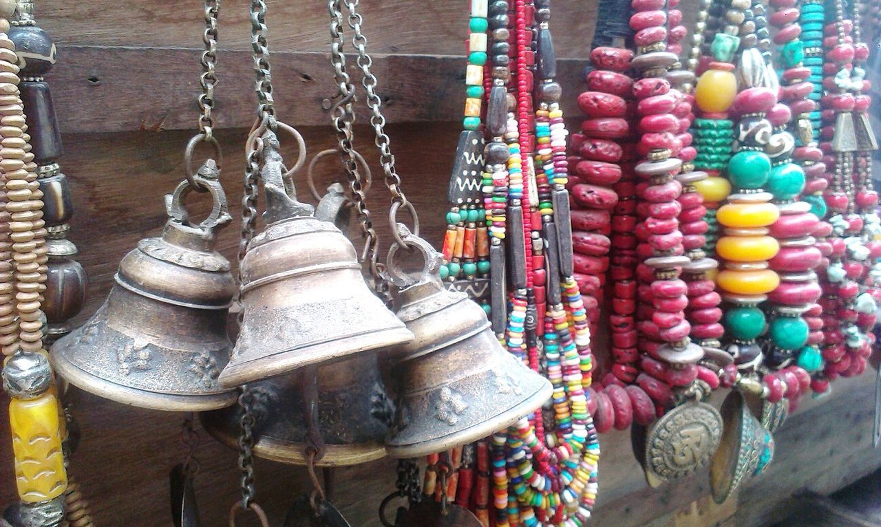 CLOSE-UP OF MULTI COLORED OBJECTS IN ROW FOR SALE