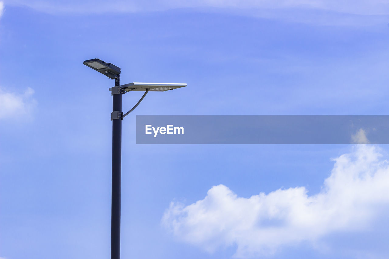 LOW ANGLE VIEW OF TELEPHONE POLE AGAINST BLUE SKY