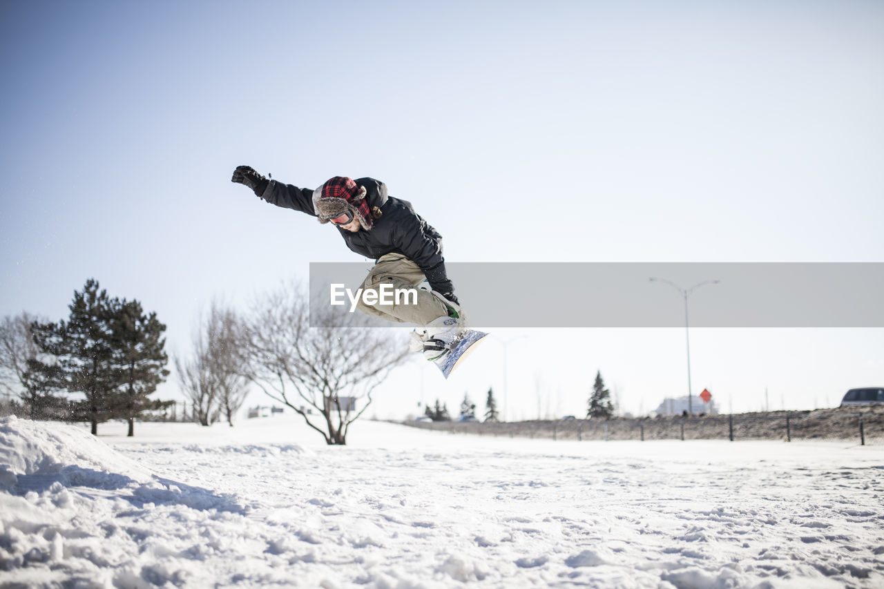 Young snowboarder in mid air doing jump