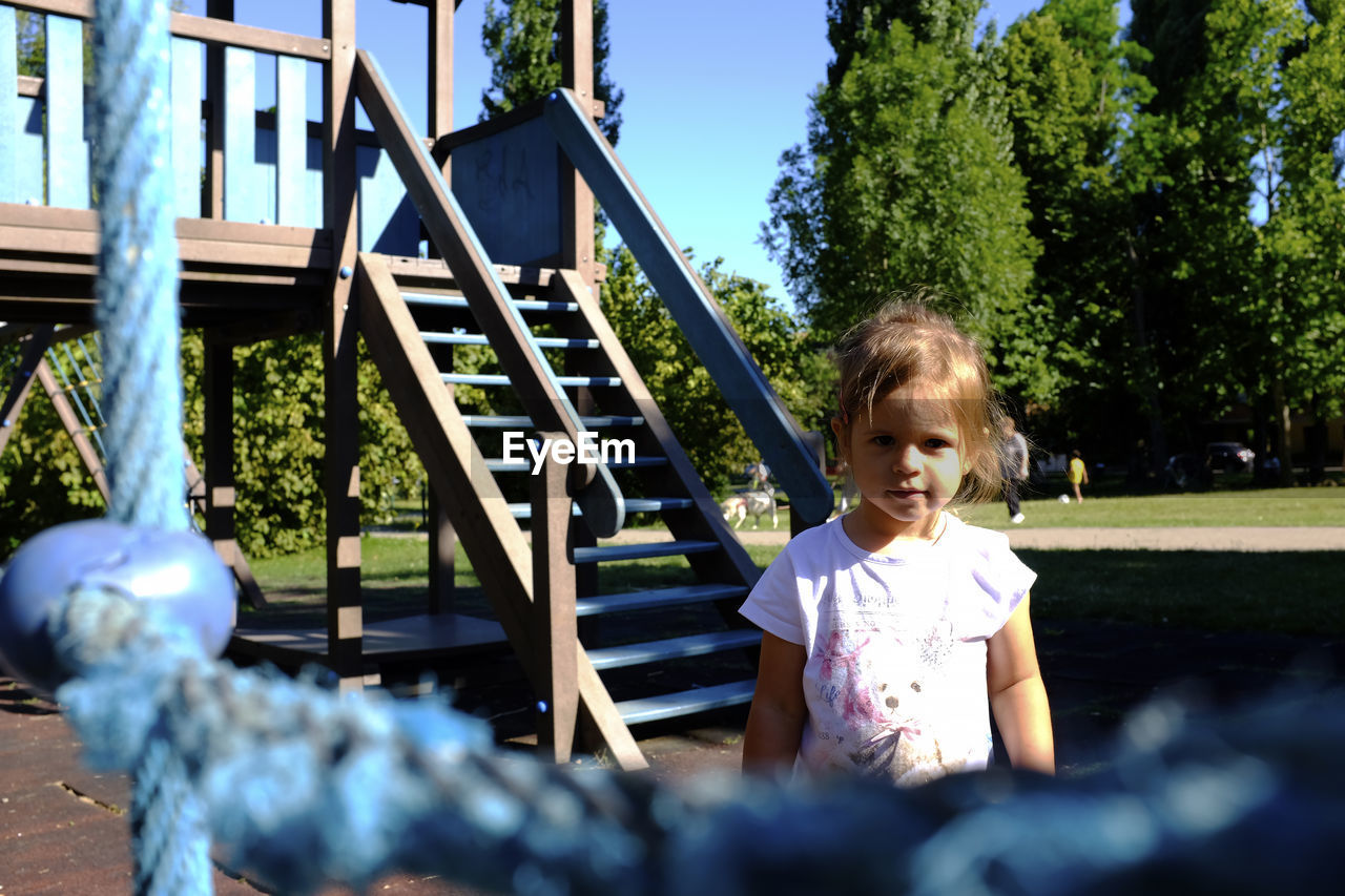 Portrait of smiling girl standing in playground