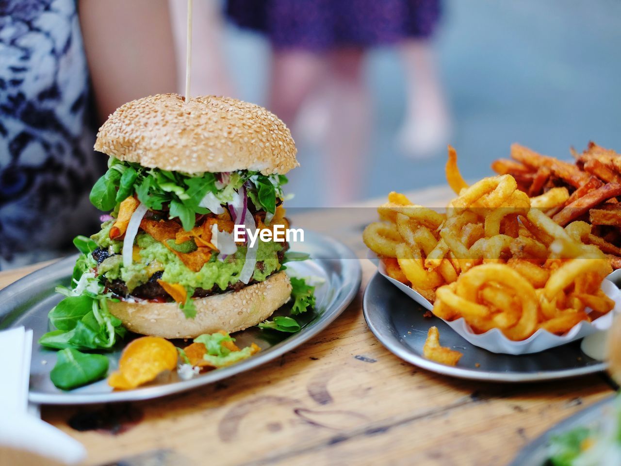 Close-up of burger and french fries in plate on table