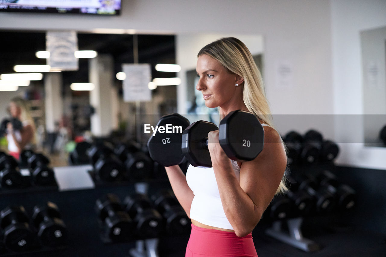 A woman strength training in the gym.