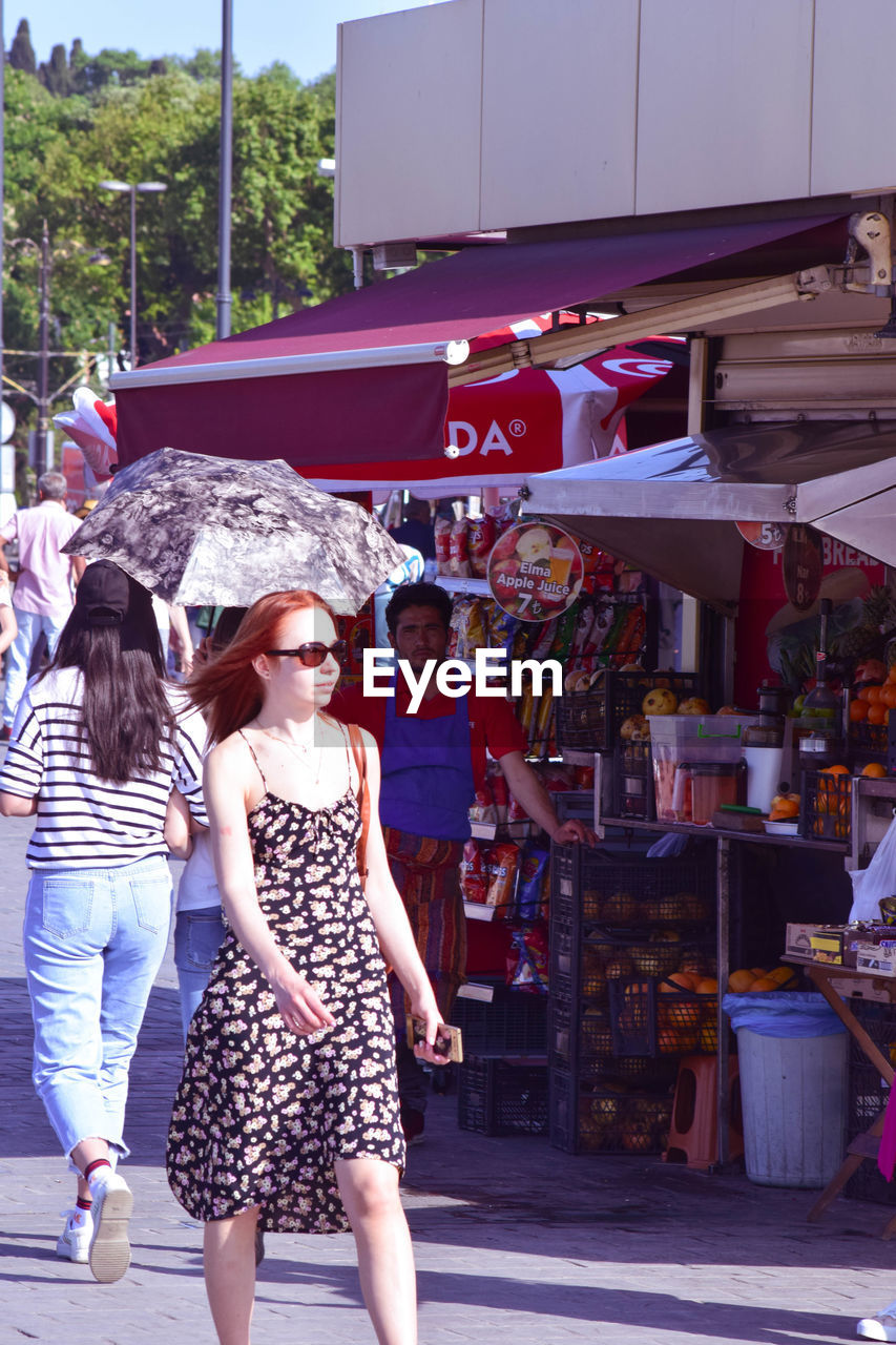 WOMEN STANDING IN MARKET