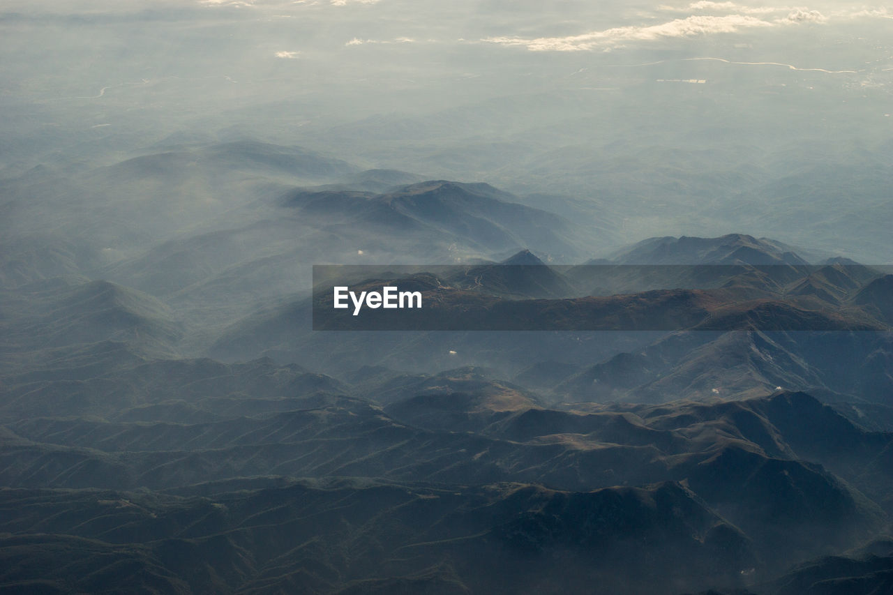 HIGH ANGLE VIEW OF MOUNTAINS AGAINST SKY