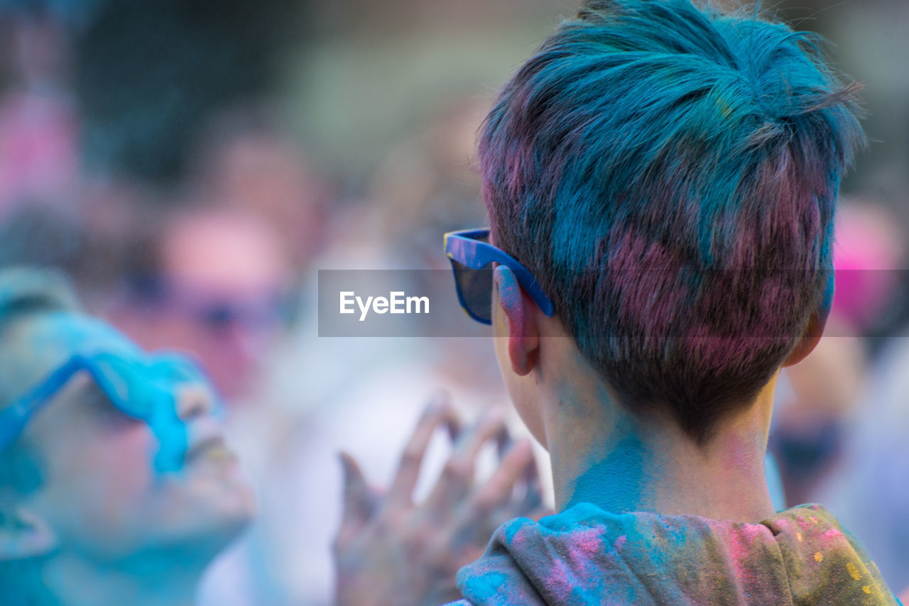 Rear view of boy covered with powder paint