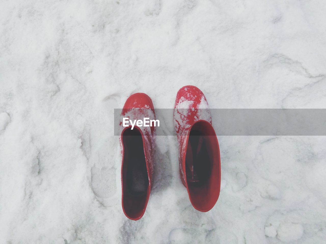 High angle view of red shoes on snow