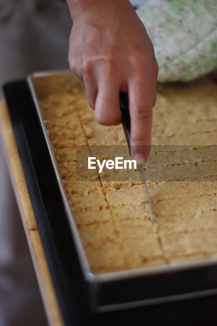 Cropped hand of person preparing food