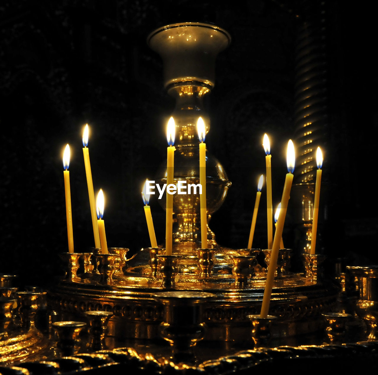 ILLUMINATED CANDLES AGAINST BUILDINGS