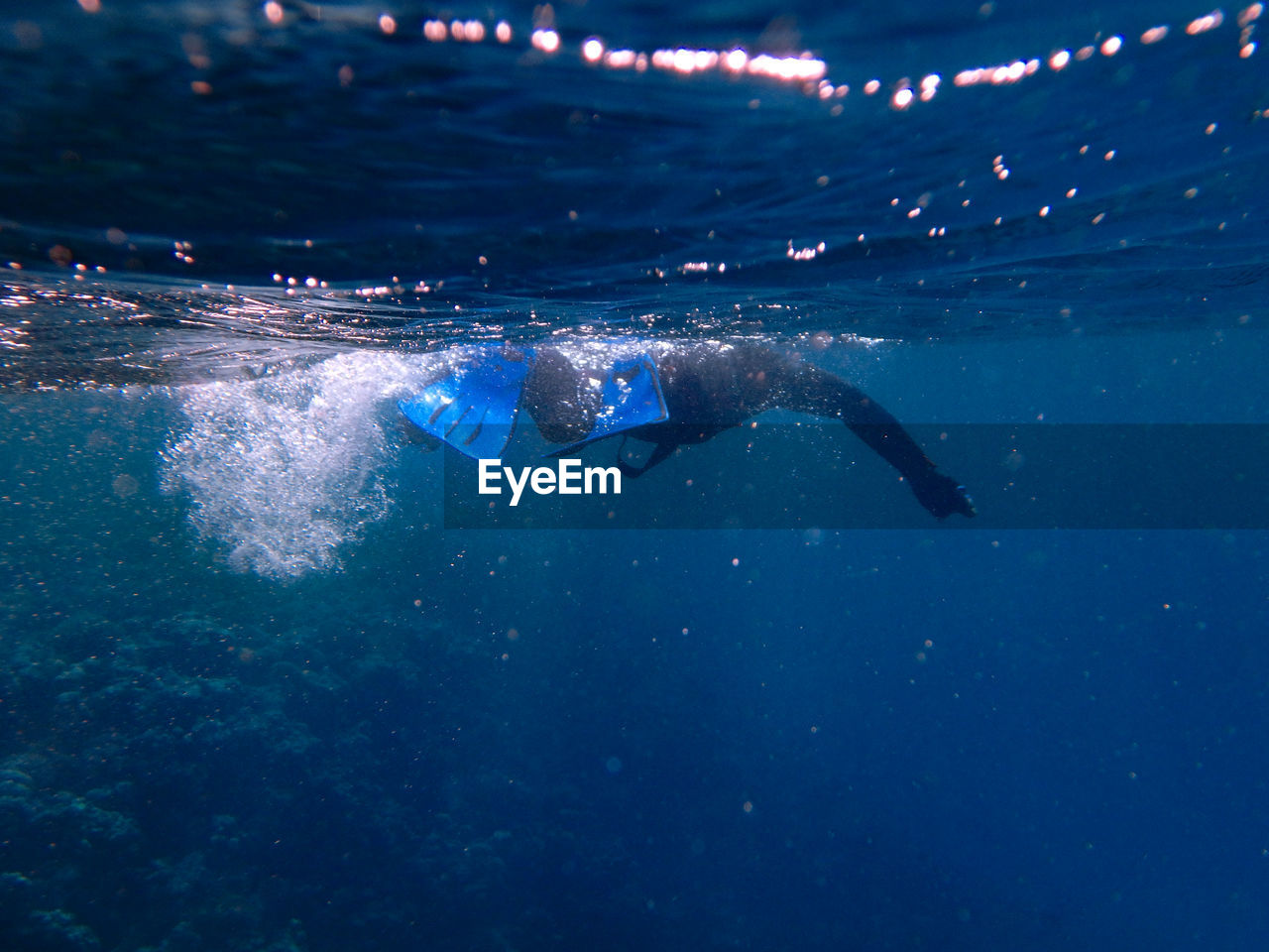 PERSON SWIMMING UNDERWATER