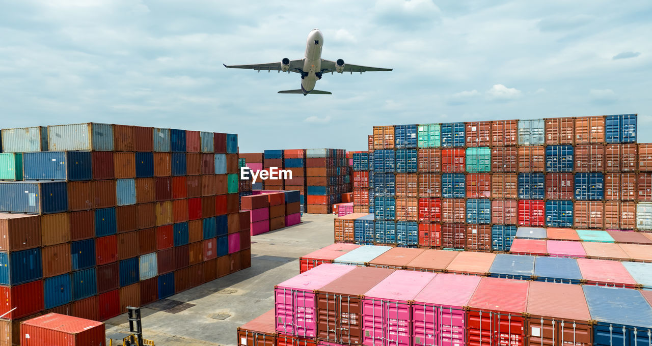 Airplane flying above container logistic. container crisis. freight transportation. logistic