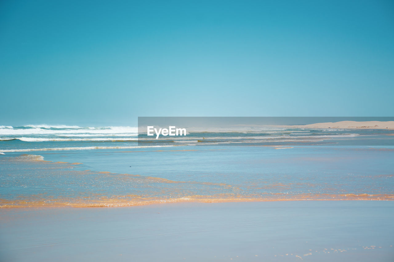 Scenic view of sea against clear blue sky